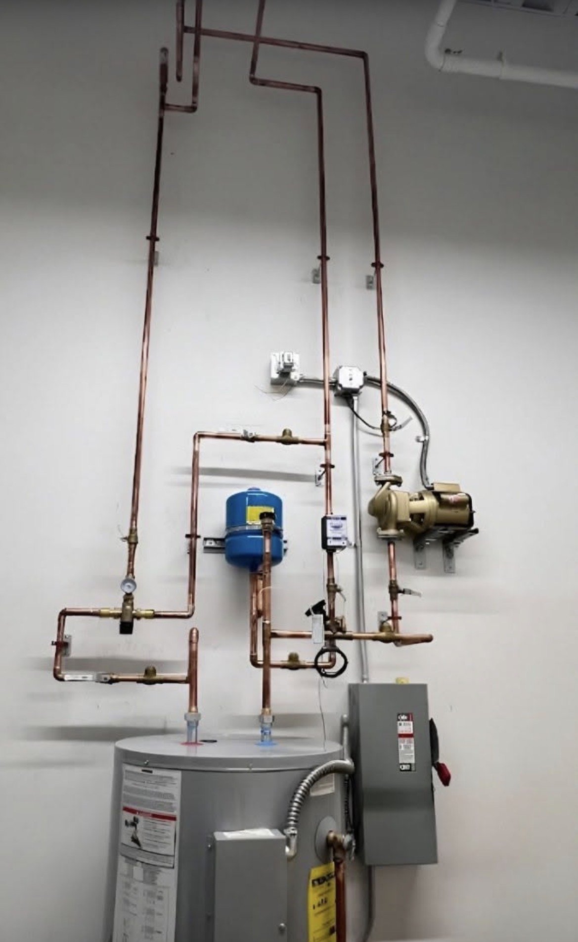 Hot water recirculation pump with copper piping and expansion tank